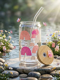 TheNStudio pastel rainbow glass tumbler with bamboo lid and glass straw, featuring a playful rainbow design.